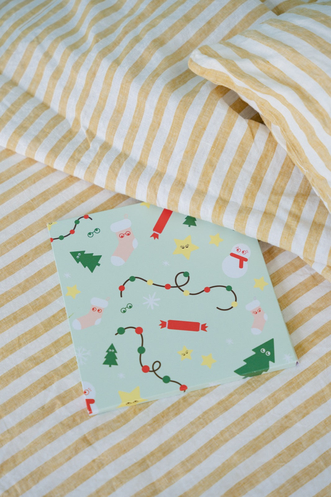 Ziggli Christmas Star personalised book flatlay on mint pattern with yellow bedding