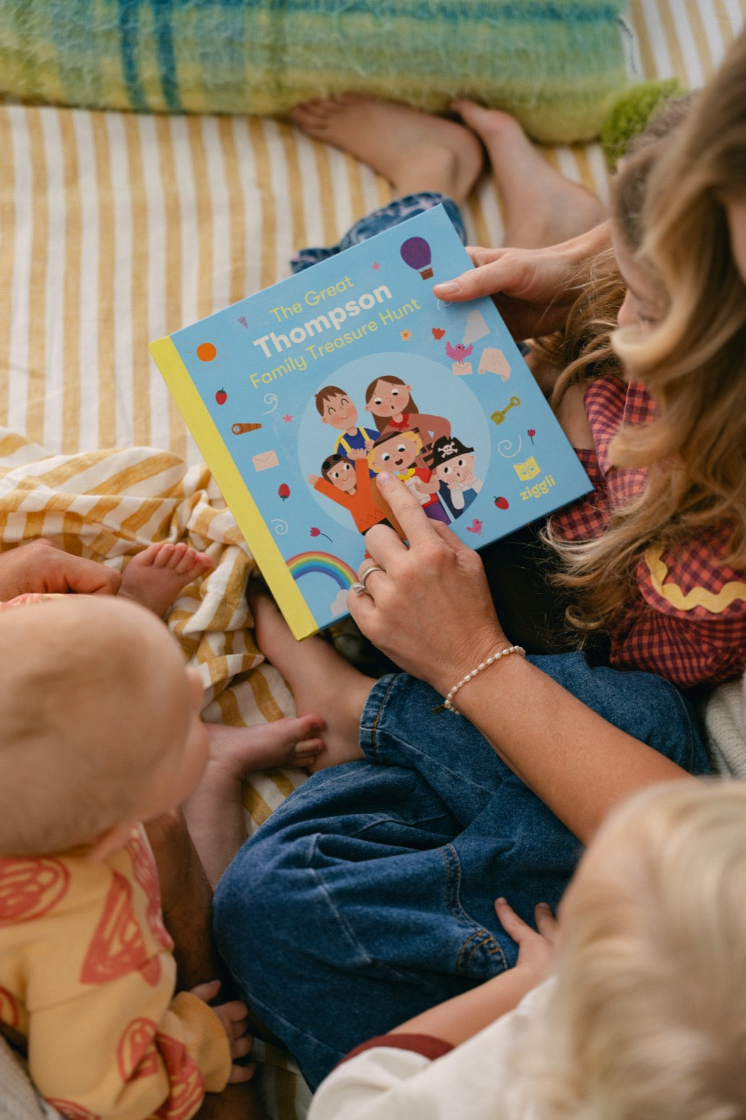 Family holding The Great Family Treasure Hunt personalised book overhead