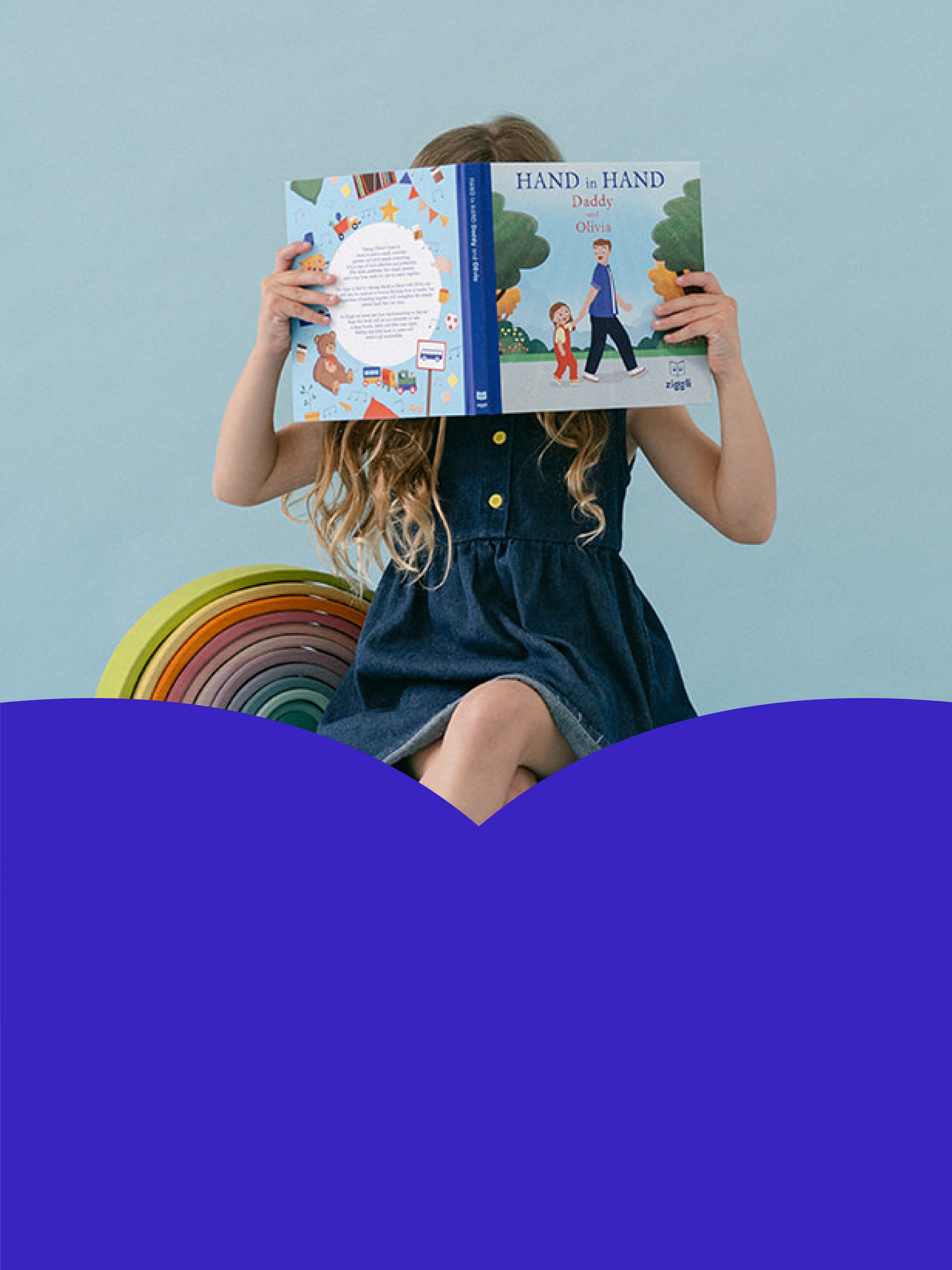 Child reading a personalised children's book titled 'Hand in Hand' against a blue background